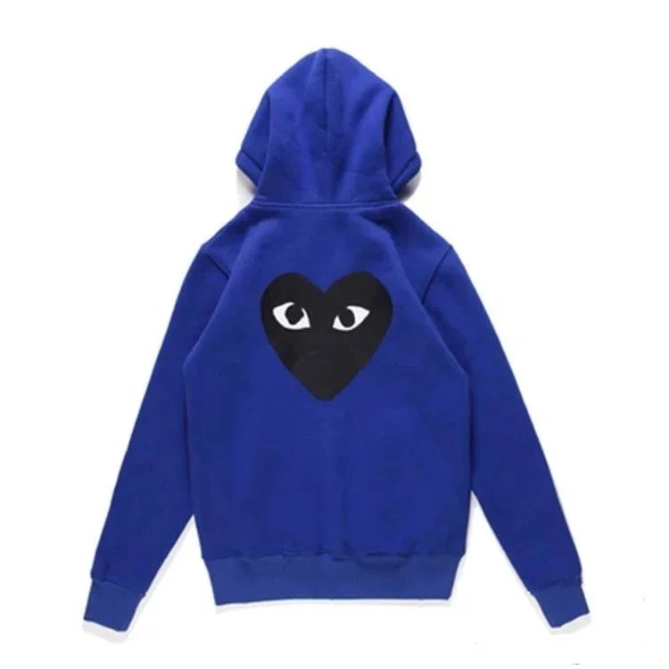 There is a big black heart behind the looped blue cardigan